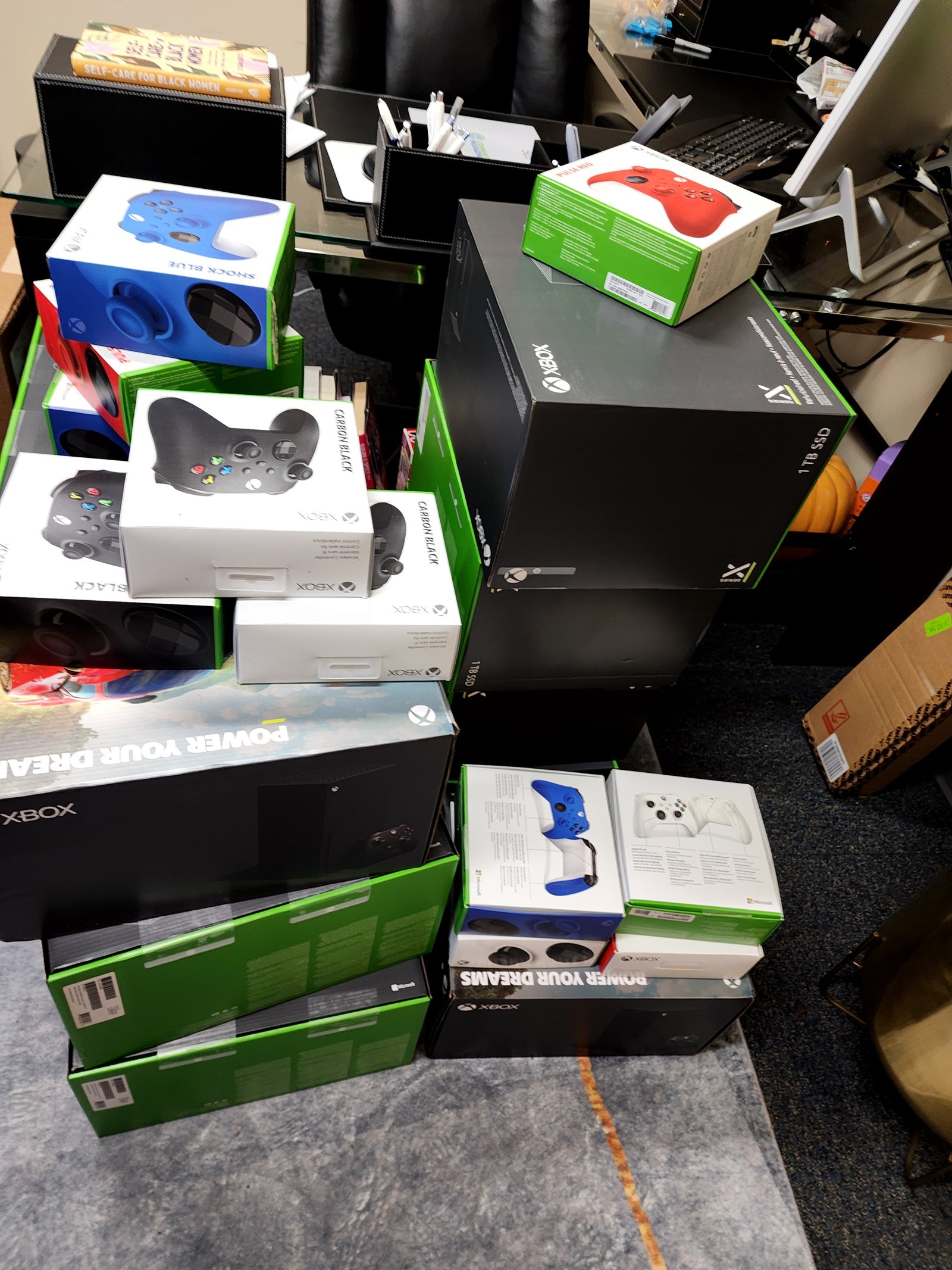 A stack of boxed electronics and game consoles