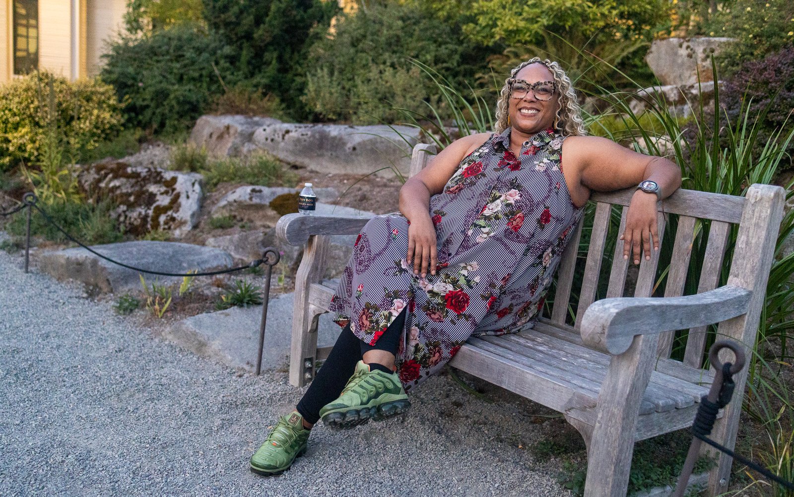 Katoya Palmer seated on a wooden bench in a garden